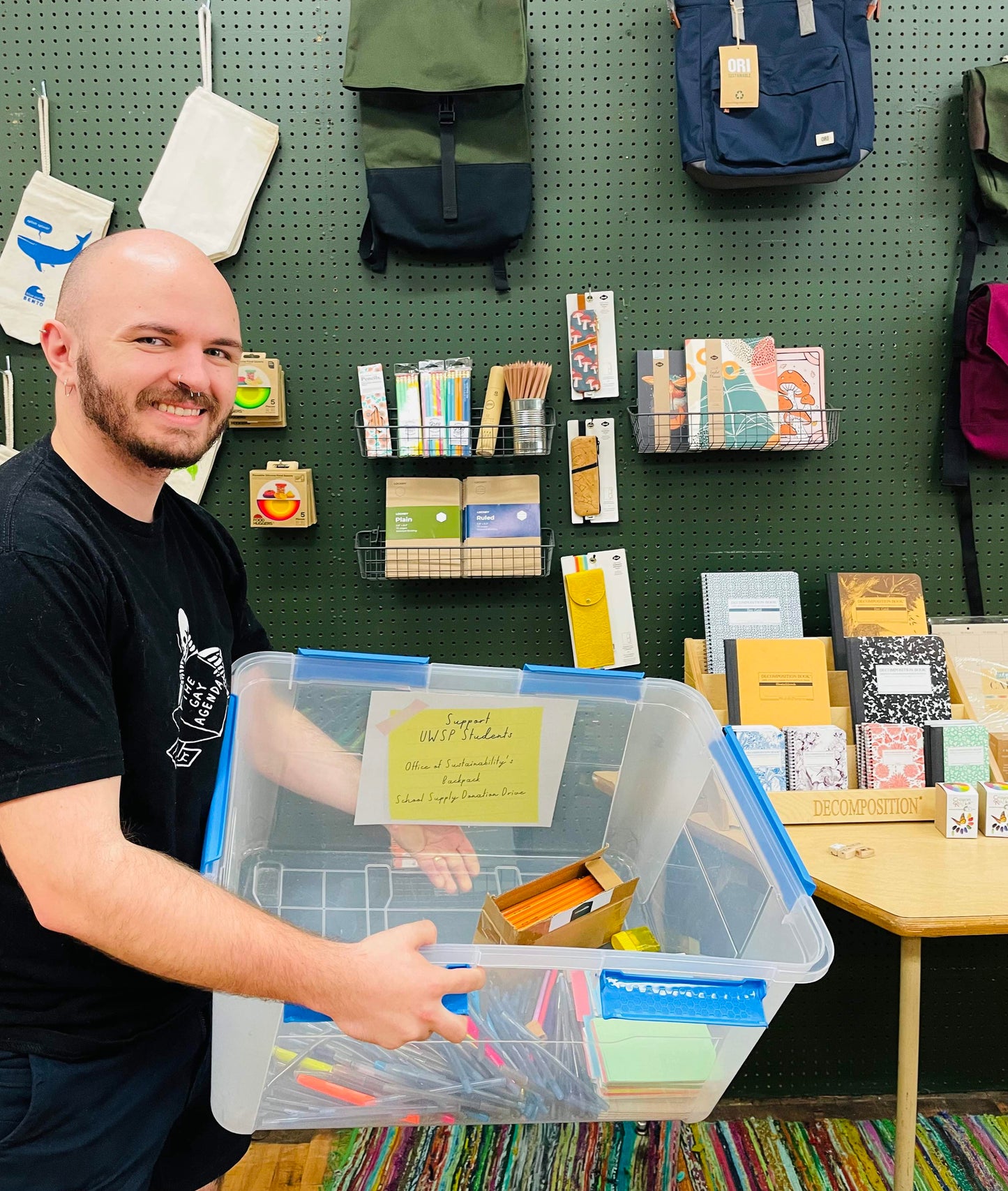 Lyn holds a box to collect school supplies for the Office of Sustainability UWSP.