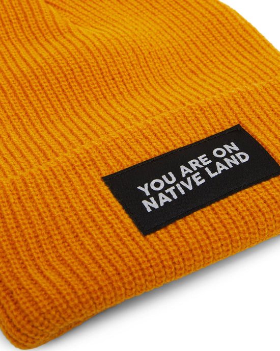 Load image into Gallery viewer, &amp;#39;YOU ARE ON NATIVE LAND&amp;#39; RIBBED BEANIE - MARIGOLD
